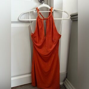 Orange halter neck dress with tie back detail.